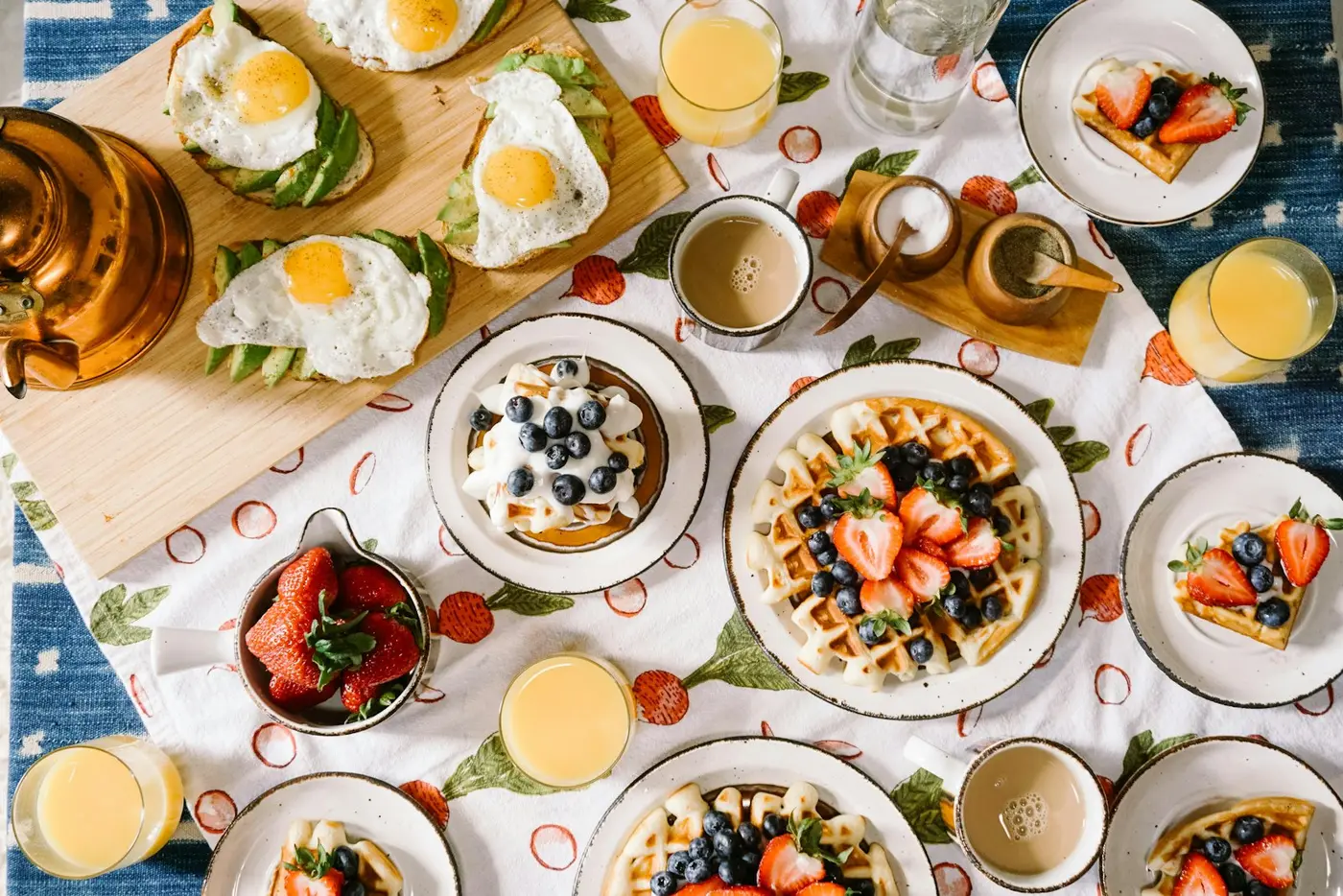 A brunch spread of waffles, eggs and juice