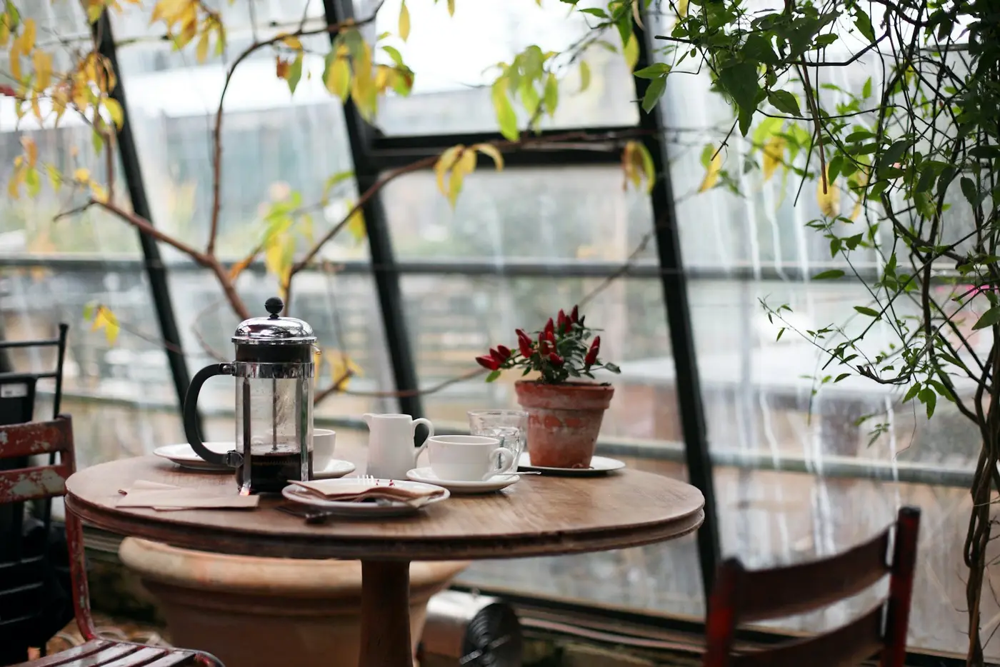 A table by the window with a pot of coffee