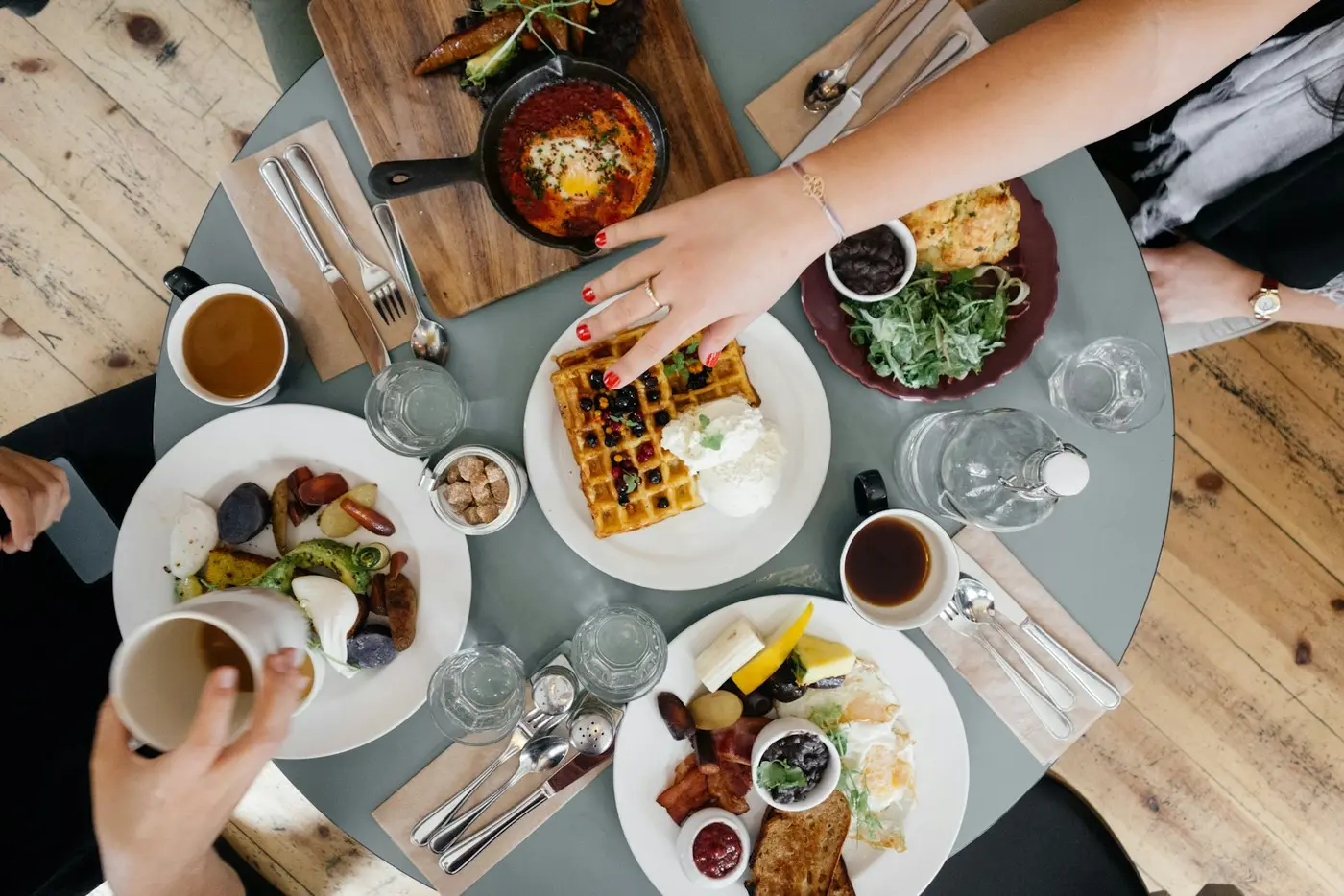 Plates being shared across a busy table